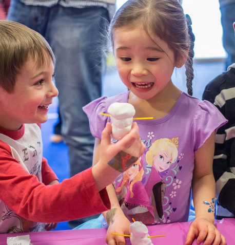Excited-Kids-Building-Snowman-458x477