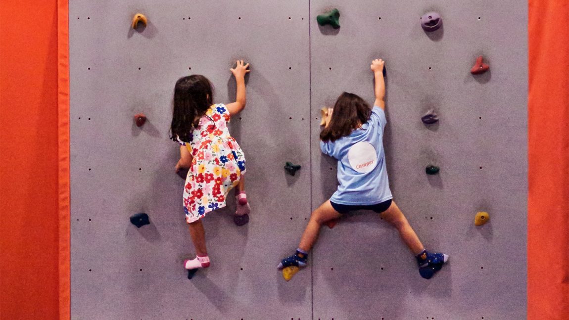 children-climbing-on-rock-wall-gym-cta-full-width-min-1150x647
