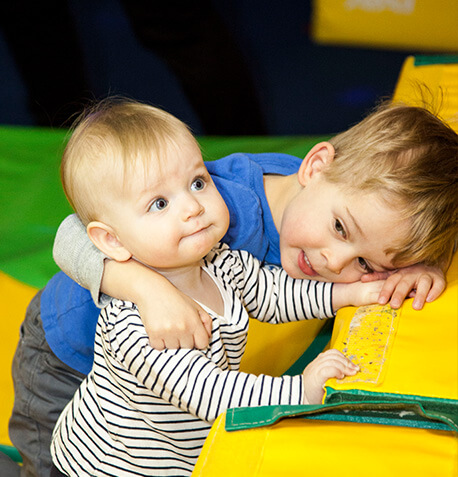 Siblings-Laying-on-Mat-in-Gym-Text-1