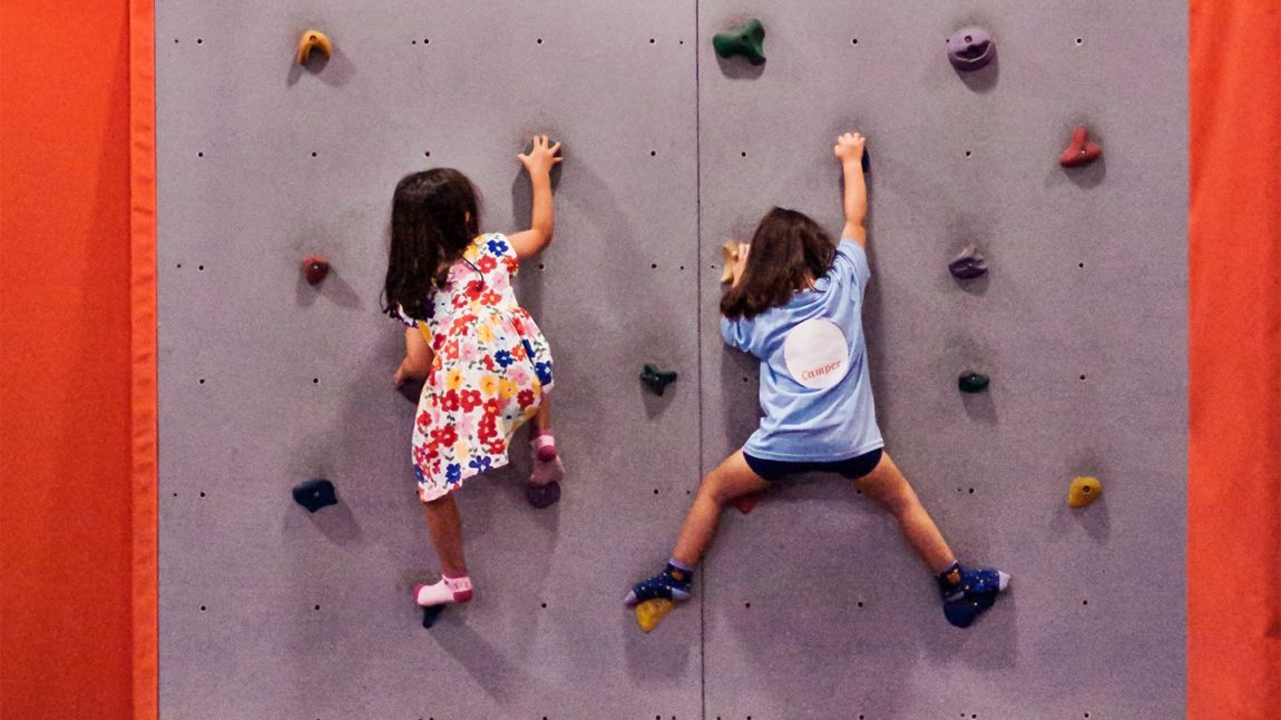 children climbing on rock wall gym cta full width-min