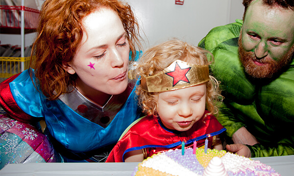 superhero birthday family blowing out candles non featured