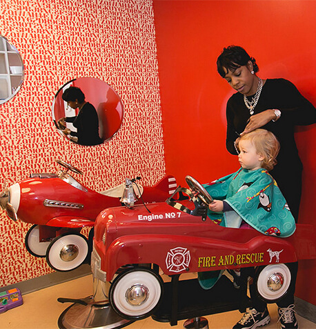 child-in-salon-fire-truck-haircut-stylist-text-image-block