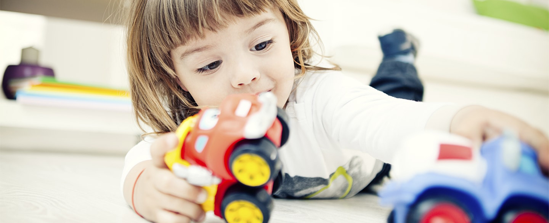child playing with cars full width-min