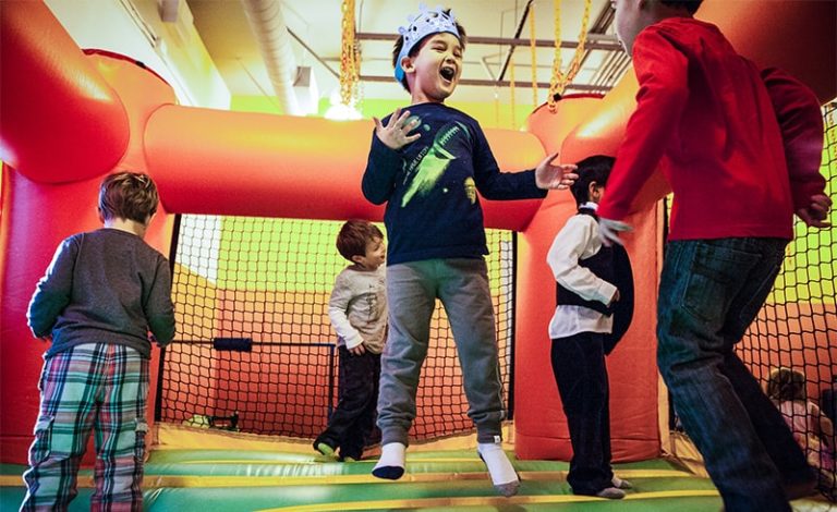 Children bouncing in the Kidville Jumpy Castle during a birthday party