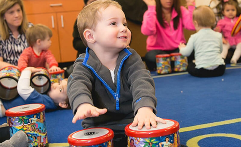 music class children playing bongos featured