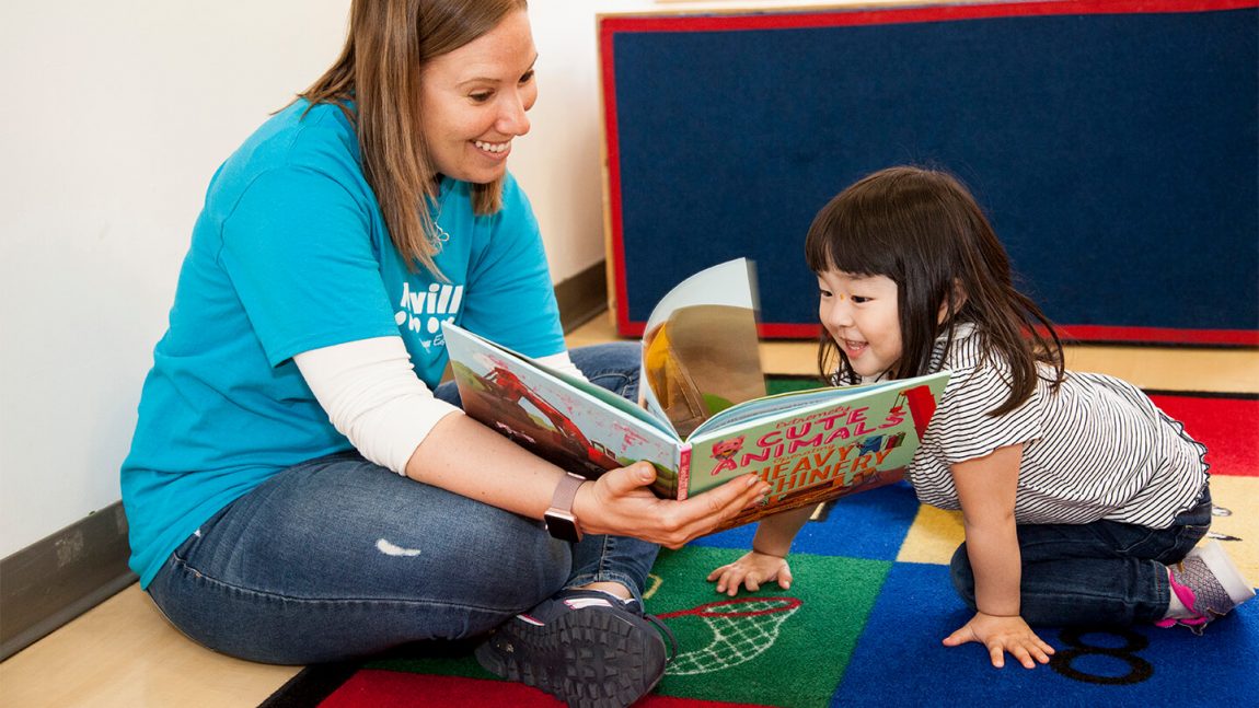 teacher reading to child on rug cta full width