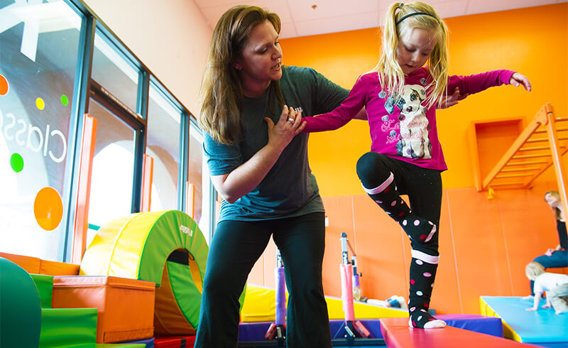 teacher child gym balance beam featured class
